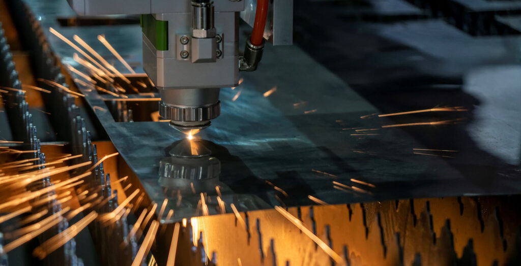 the fiber laser cutting machine make hole on the sheet metal plate with the sparkling light.