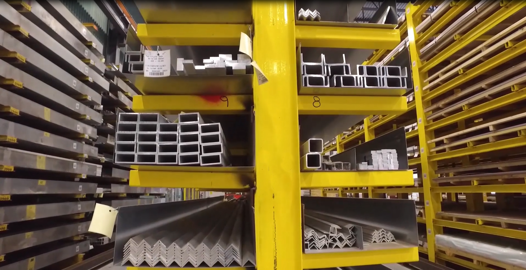Yellow open shelves holding various shaped metal posts